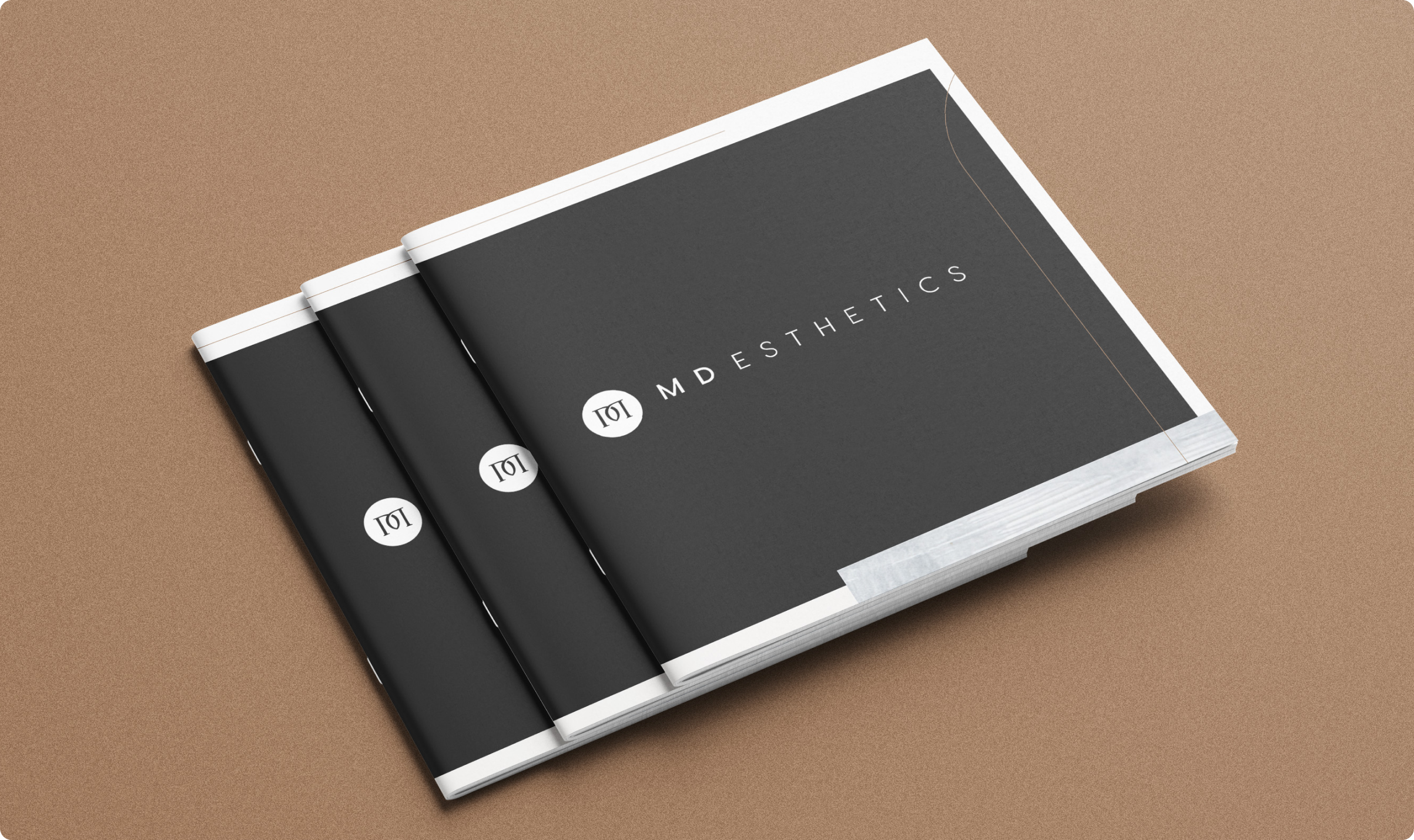 3 printed books featuring the cover "MD Esthetics"
