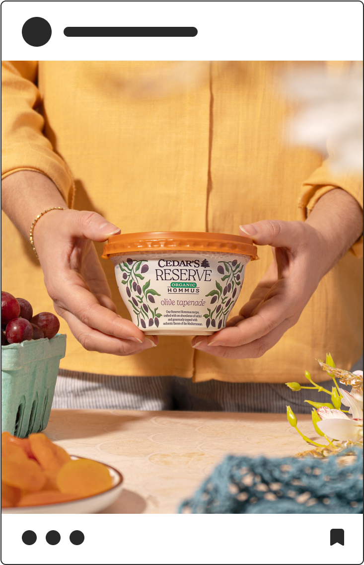 Social media post photograph of Cedar's Reserve Hommus in hands